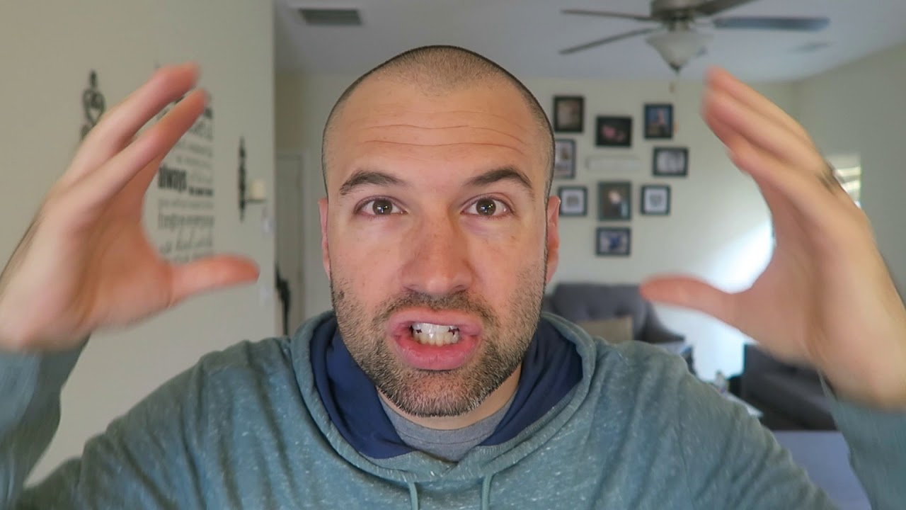 Man with a clean 0 guard buzz cut, even length all over