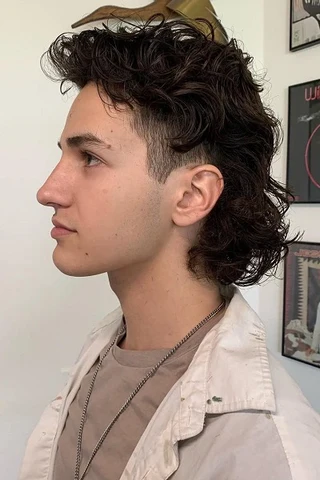 Modern burst fade haircut on wavy hair with a sharp yet relaxed finish.