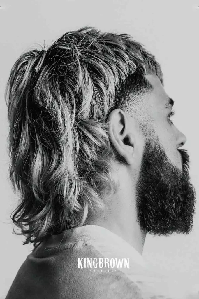 Modern burst fade mullet with long hair, featuring clean burst fade on the sides and longer hair at the back, edgy burst fade long hair style.