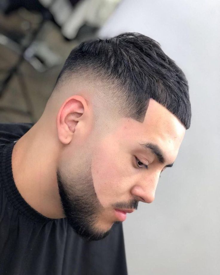 French crop burst fade on straight hair with clean fringe and sharp taper around the ears.
