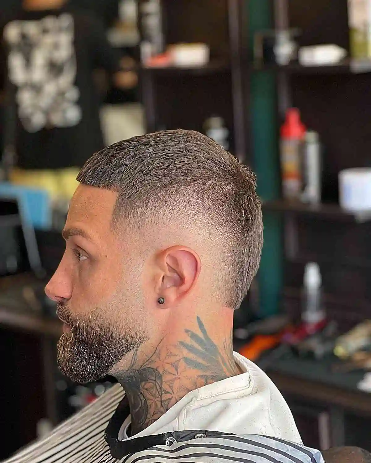Burst fade buzz cut on straight hair showing a sharp, clean transition around the ears.