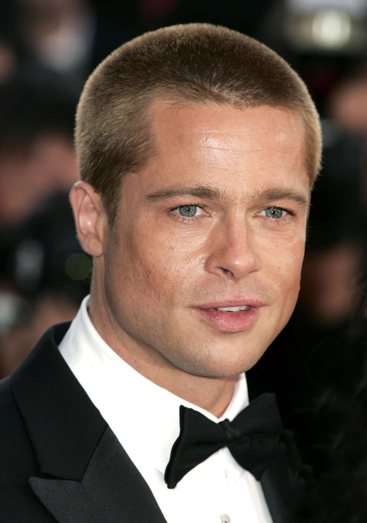 Brad Pitt showcasing iconic buzz cut hairstyle in a confident pose, inspiring men's grooming trends