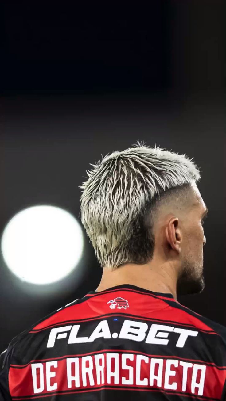 Stylish man with buzz cut mullet hairstyle showing short sides and longer back for edgy look.