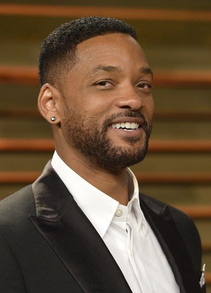 Black man with a classic even-length buzz cut, clean lineup, and defined beard