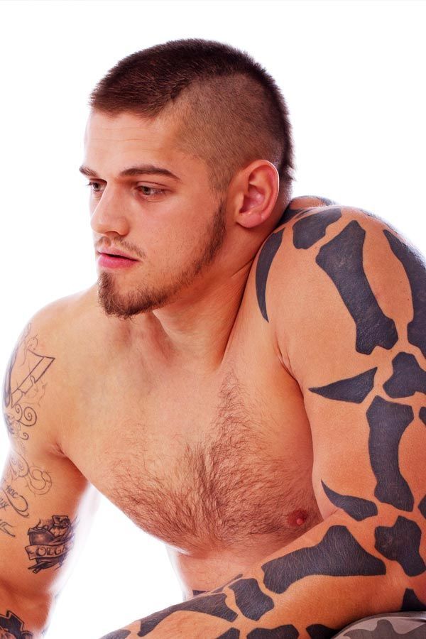 Man rocking a classic Mohawk buzz cut with faded sides for an edgy, confident look.