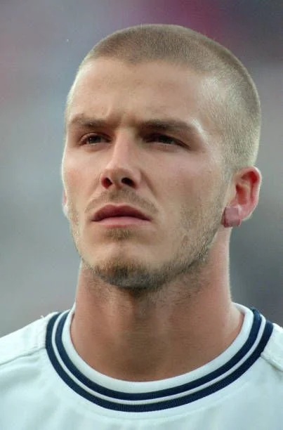 Men with square face sporting David Beckham buzz cut, highlighting hairstyle versatility.