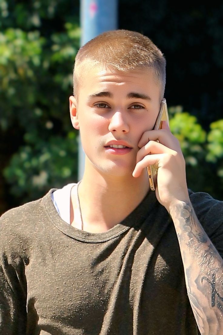 Justin Bieber rocking a fresh buzz cut in NYC, 2025, showcasing a bold, clean shaven hairstyle.