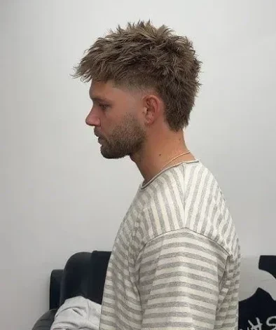 Textured messy mullet haircut with layered volume for men